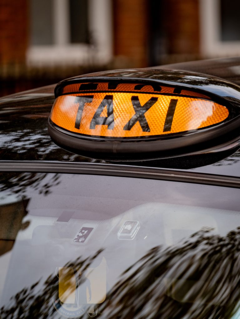 Orange light on a cab that says 'TAXI'